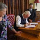 Waitaki Mayor Alex Familton (centre) signs the district up to the first step towards it becoming...