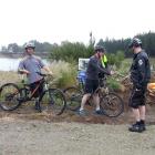 Waitaki Mayor Gary Kircher (centre)  cuts a bicycle tyre inner tube to officially open recently...
