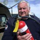 Waitaki Rural Chief Fire Officer Eric Spittal checks the level of the fire extinguisher used at a...