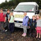 Waitati School pupils ready to board their bus at the school are (from left) James Burchell (9),...