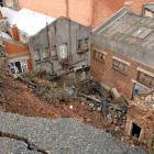 Bluestone from the collapsed wall between Dowling and Rattray Sts will be sold as salvage. Photo...
