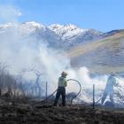 Wanaka firefighters tend to a blaze beside Cardrona Valley Rd yesterday afternoon. Photo by...