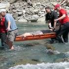 Wanaka LandSAR volunteers carry out a tramper who suffered two leg fractures in a fall in...