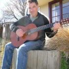 Wanaka musician Steve Brett at home with his classical guitar.  Photo by Marjorie Cook.