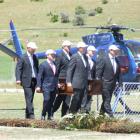 Wanaka Pallbearers carry the casket of Morgan Saxton into his funeral at Wanaka Airport yesterday...