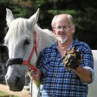 Wandering horseman Keith Roberts holds the manure of his horse Zara in Berwick. Photo by Linda...