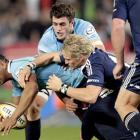 Waratahs' fullback Kurtley Beale, left, is tackled by Stormers' fullback Joe Pietersen. Stormers...
