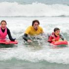 Warrington Surf Lifesaving Club summer holiday programme head instructor Isaac Davies (centre)...