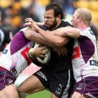 Warriors' Sam Rapira is tackled by Storm's Jeff Lima, left, and Michael Crocker. Photo by NZPA.