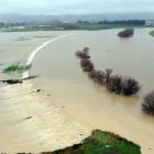 Water pours out of the Taieri River into the upper ponding area near Riverside Rd, near Outram,...