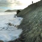 Waves begin eating away at recently dumped sand at Middle beach as the tide rises yesterday...