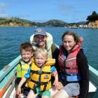 Wayne Johnson, Anna Hughes and their sons, Eli (left) and Niwha, head for home after a day in...