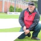 Wayne Walker, the new groundsman at Molyneux Park, adjust the covers at the University Oval...