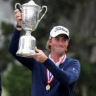 Webb Simpson of the US holds the trophy after winning 2012 US Open on the Lake Course at the...