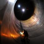 Welder Murray Ewing uses a grinder inside a milk silo at Fonterra's Edendale plant yesterday....