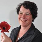 Wendy Boyne, of the Mosgiel RSA, holds the Tower of London Ceramic Poppy  given  to the Mosgiel...