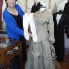 Wendy Williamson, of Forno's Auctioneers, displays an 1880s wedding gown and accessories which...