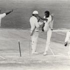West Indian fast bowler Michael Holding kicks over the stumps in frustration after a decision for...