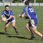 Whalers captain Isaac Misky looks to pass to loose forward Adam Tapsely in the game against...