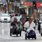 Wheelchairs and scooters lead the way on George St. Photo by Peter McIntosh
