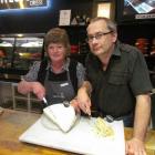 Whitestone Cheese employees Chris Thompson and Martyn Hall carve into a slab  of blue cheese....