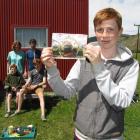 William Lorimer (14) displays his winning photo while mum Michelle, dad Mike and brothers Tom (10...
