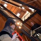 Winston Fenton (left) installs an LED light fitting in the Dunedin warehouse of ADInstruments...
