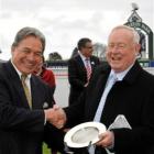 Winston Peters (left) presents Barry Thomas with the trophy for the Winter Classic at Riccarton...