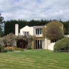 With a shelter belt behind it and sweeping lawns in front, the Clelands' home is perfectly...