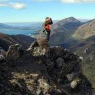 With Lake Hawea and the Hawea township well below, Wal Shuttleworth glasses for deer from a rocky...