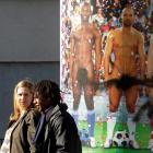 Women pass by a poster advertising the Leopold Museum's 'Naked Men' art exhibition in Vienna,...