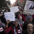 Women shout slogans against Egyptian President Mohamed Morsi and members of the Muslim...