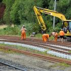 Workers assemble railway tracks at the old Wingatui rail-yard to test the safest way to replace...