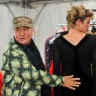 World co-founder Francis Hooper fits one of his gowns to a model backstage at the iD Dunedin...