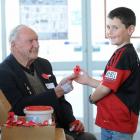 World War 2 veteran Theo Gray (85) sells a poppy to Charlie Gilbert (8), of Oamaru, on Thursday....