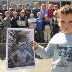 Wyatt Scholten (5) holds a photograph of himself which was first equal in the New Zealand Best...