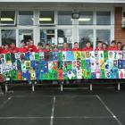 Year 7 and year 8 pupils from Rosebank Primary School's room 8 display the painting they are...