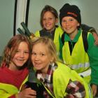 Young volunteers going up in the gondola ready to pull out wilding conifers yesterday are (front,...