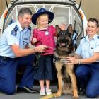 Youngster Chakra Mattingly (6) enjoys a close encounter with Dunedin police dog Fonz, while...