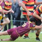 Zingari-Richmond lock Tom Rowe is tackled by Alhambra-Union halfback Caleb Gray at Montecillo...