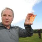 Zoomtech chief executive Richard Cathro holds the new tee his company has designed, as Chisholm...