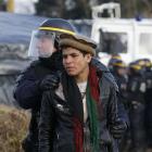 A French CRS riot policeman apprehends a young Afghan during a protest by migrants against the...