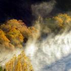 Fog rises off the Hawea River in the early morning. Photo: Stephen Jaquiery
