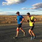 Glenn Sutton (left) gets support from Greg Yee on his Alps 2 Ocean cycle trail run on Saturday....