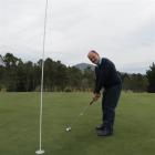 Island Park Golf Club committee member Peter Bezett tests out a green in preparation for the club...
