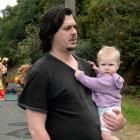 Nathan Ladbrook holds  Evelyn Ladbrook (8 months) as fire engulfs their Ravensbourne Rd home...