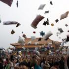 Participants throw their pillows during the International Pillow Fight Day at Liberty Square, in...