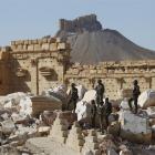 Syrian army soldiers stand on the ruins of the Temple of Bel in the historic city of Palmyra, in...
