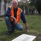 Waitaki District Council parks officer Mike Kwant inspects a grave from which the headstone was...