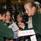 Emily Templeton (10), of the Terrace School in Alexandra, discusses answers with her teammates at...